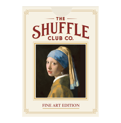 Front of Shuffle Club Co. Fine Art Edition playing cards package featuring the Girl with a Pearl Earring artwork in the center beneath the Shuffle Club Co. logo on a cream-colored box labeled "Fine Art Edition".